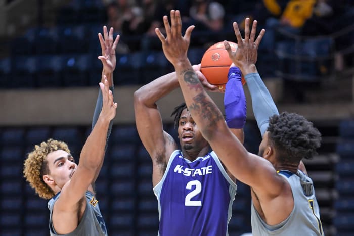 West Virginia forwards Emmitt Matthews Jr (left) and Derek Culver (1) harass Kansas State forward Selton Miguel (2).
